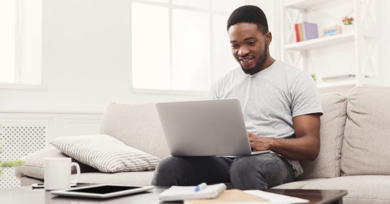 4 Reasons Zero-Sum Budgets Are Awesome - picture of man at laptop on his couch