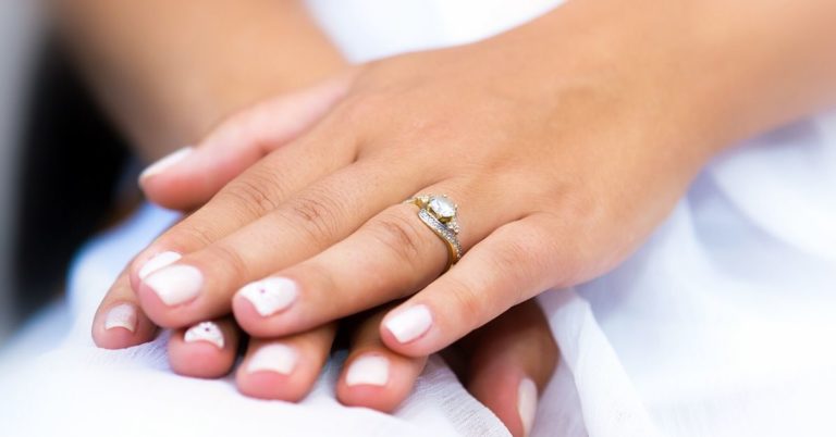 Are Diamond Engagement Rings Overrated - picture of woman's hand with diamond ring on ring finger