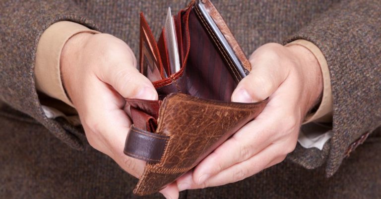 Are Your Finances Out of Control - picture of man holding out empty wallet