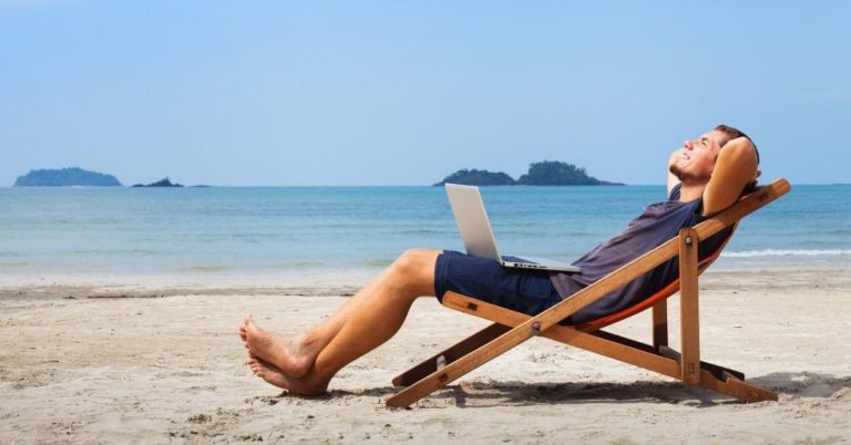 Axos Bank Review - picture of man relaxing at beach in chair with laptop in lap