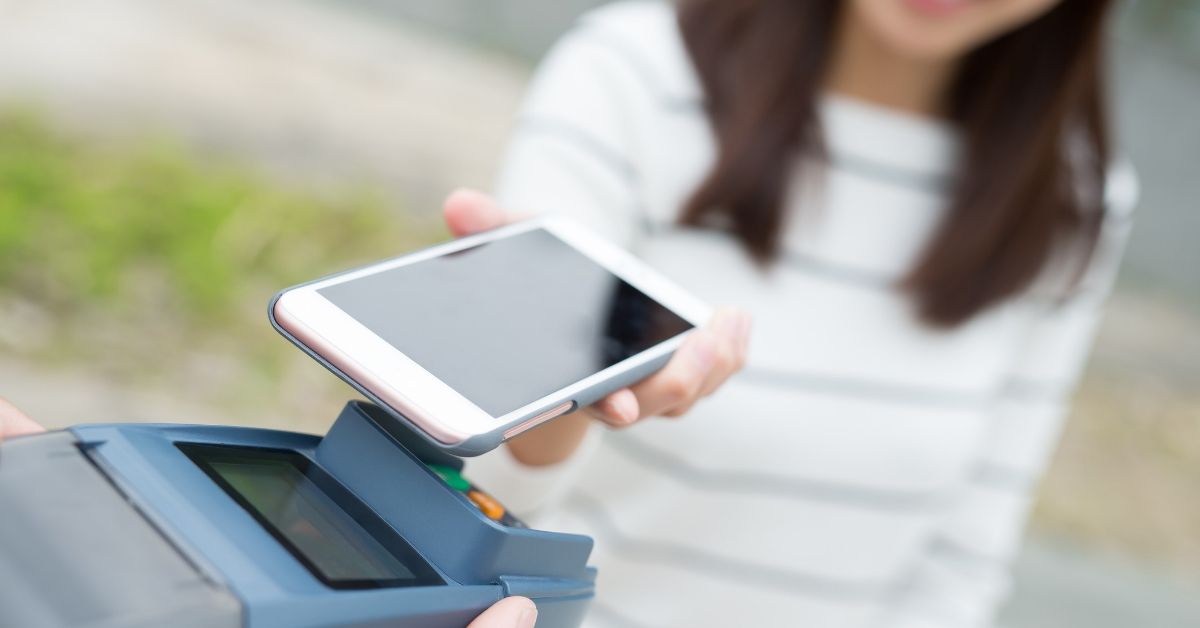 Best Checking Accounts - picture of woman paying with smartphone