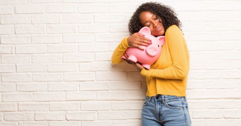 Betterment Everyday Savings Review - picture of woman hugging piggy bank