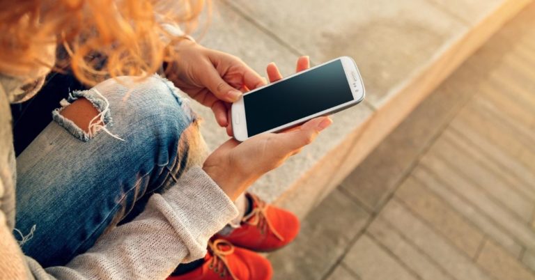 Can You Really Afford a Smartphone - picture of woman's hands holding smartphone