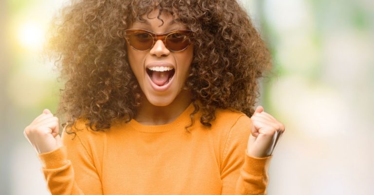 CIT Bank eChecking Review - picture of Black woman in sunglasses with raised fists and happily yelling