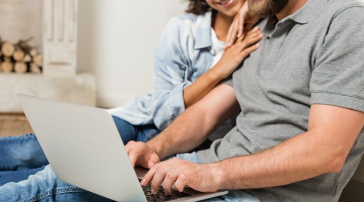 image of couple completing their work from home jobs on their computer