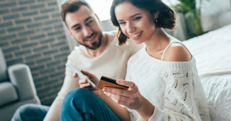 Debitize Review - picture of couple with credit card and phone