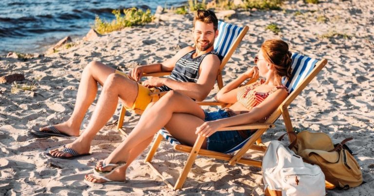 Do's and Don'ts For Saving on Travel - picture of young couple in beach chairs