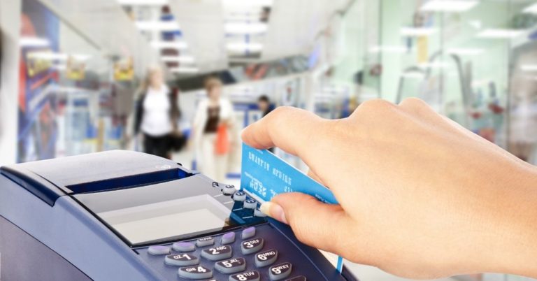 Easy Ways to Refinance Credit Card Debt - picture of hand putting credit card through credit machine