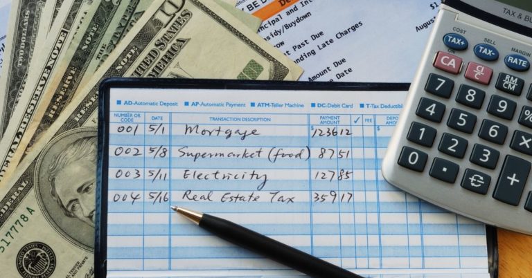 50-20-30 Budget Rule - picture of checkbook calculator and cash