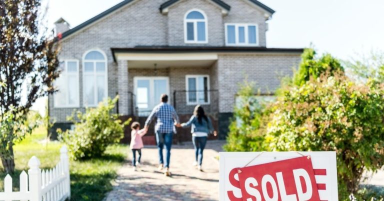 House Shopping The Addiction Continues - picture of parents and child running toward house with sold sign