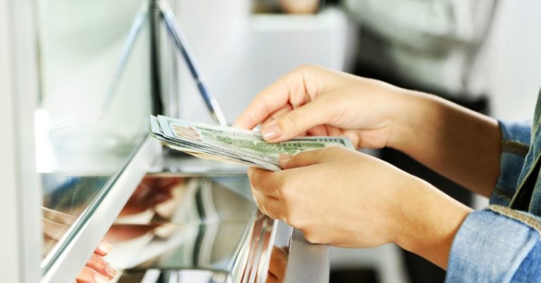 How I Made $200 This Week for Doing Nothing - picture of woman's hands with cash at teller window