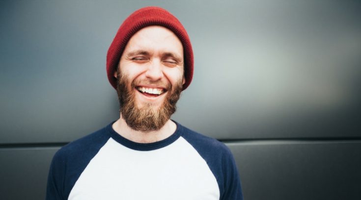 image of bearded man in stocking hat who is laughing