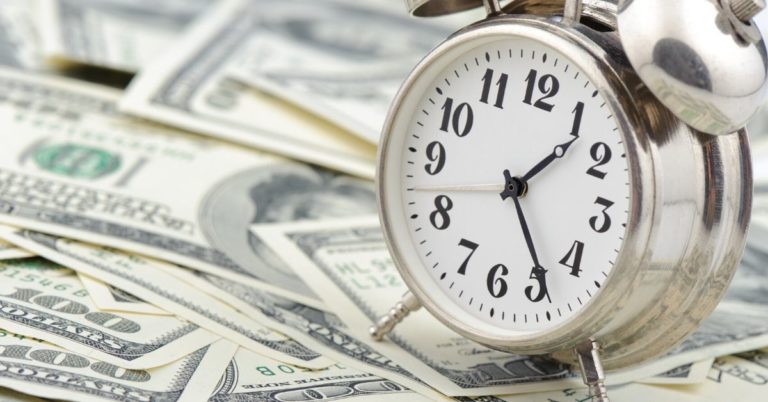 Money is Time for the Future - picture of alarm clock sitting on cash