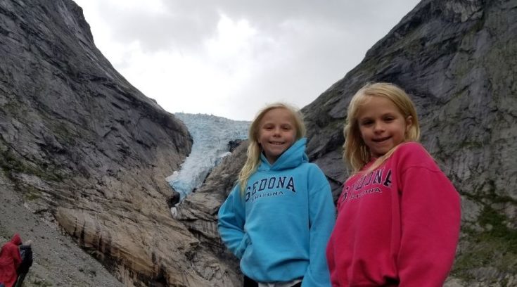 Photo of two girls in front of a glacier