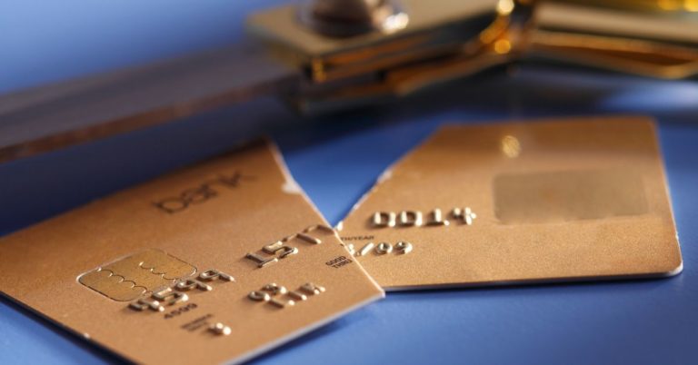 Payoff Personal Loan Review - up close picture of cut credit card with scissors in background