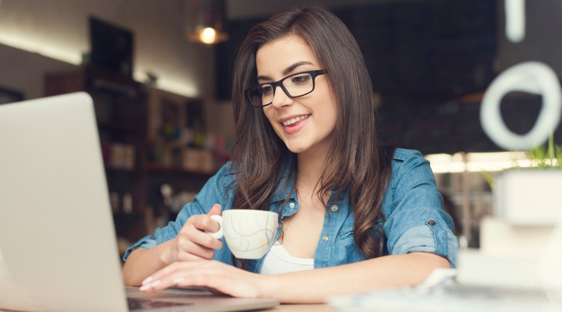 personal capital vs. quicken - photo of woman drinking coffee on computer