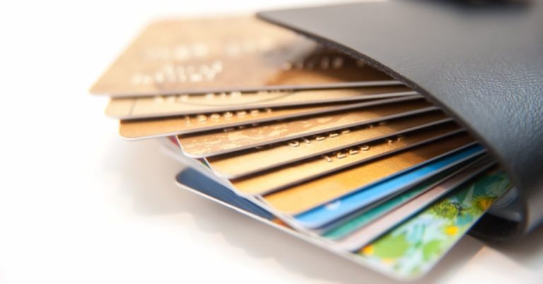 How to use a personal loan to pay off credit card debt - picture of wallet full of credit cards