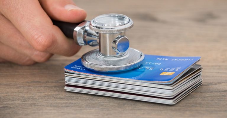 Simple Steps to Improve Your Credit Score By 100 Points - picture of stack of credit card with stethoscope on them