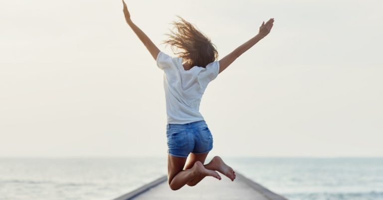 SoFi Personal Loans Review - picture of back of woman jumping on pier