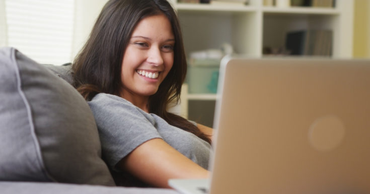 Swagbucks Review - picture of woman smiling at her laptop