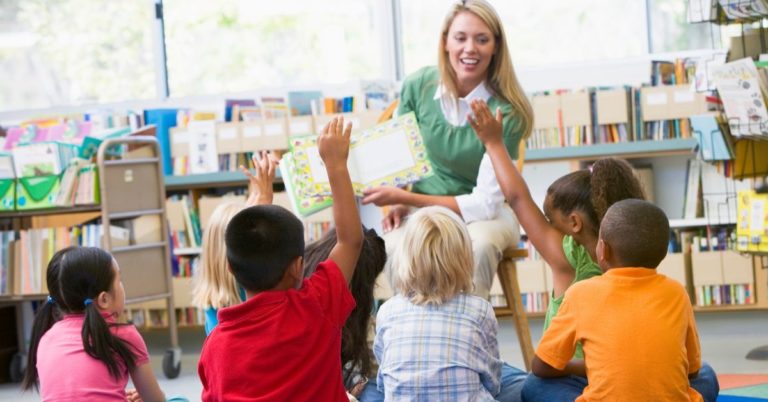 TEACH Grant Review - picture of female teacher reading to young kids