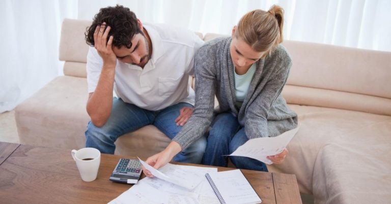 The Amazing Power of Debt - picture of couple stressed about bills