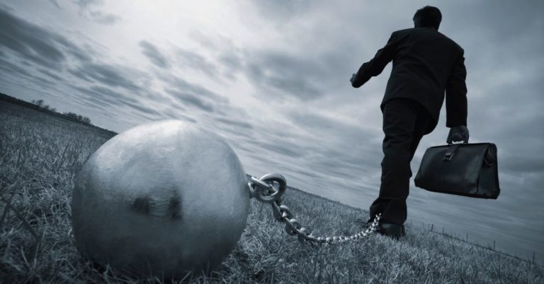 Ways to Slow Down Interest and Get Ahead Faster - picture of businessman walking away with ball and chain attached