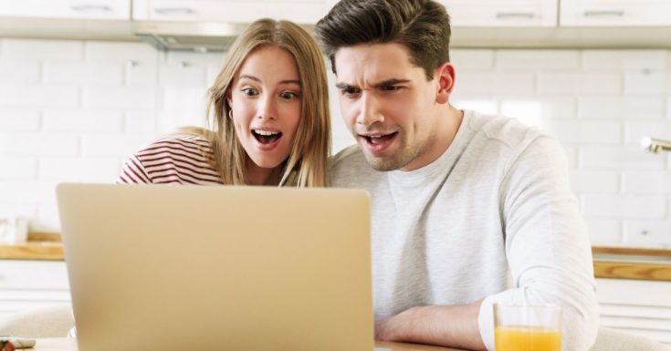 What is a Zero-Based Budget - picture of couple looking at laptop screen with surprised look on their faces