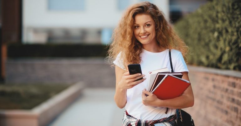 What is Income-Based Repayment Plan - picture of female college student with smartphone and books