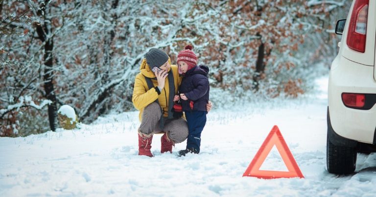 Why I'm Glad I Have Emergency Fund - picture of woman and child with broken down car in the snow