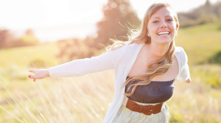 image of woman smiling in a field