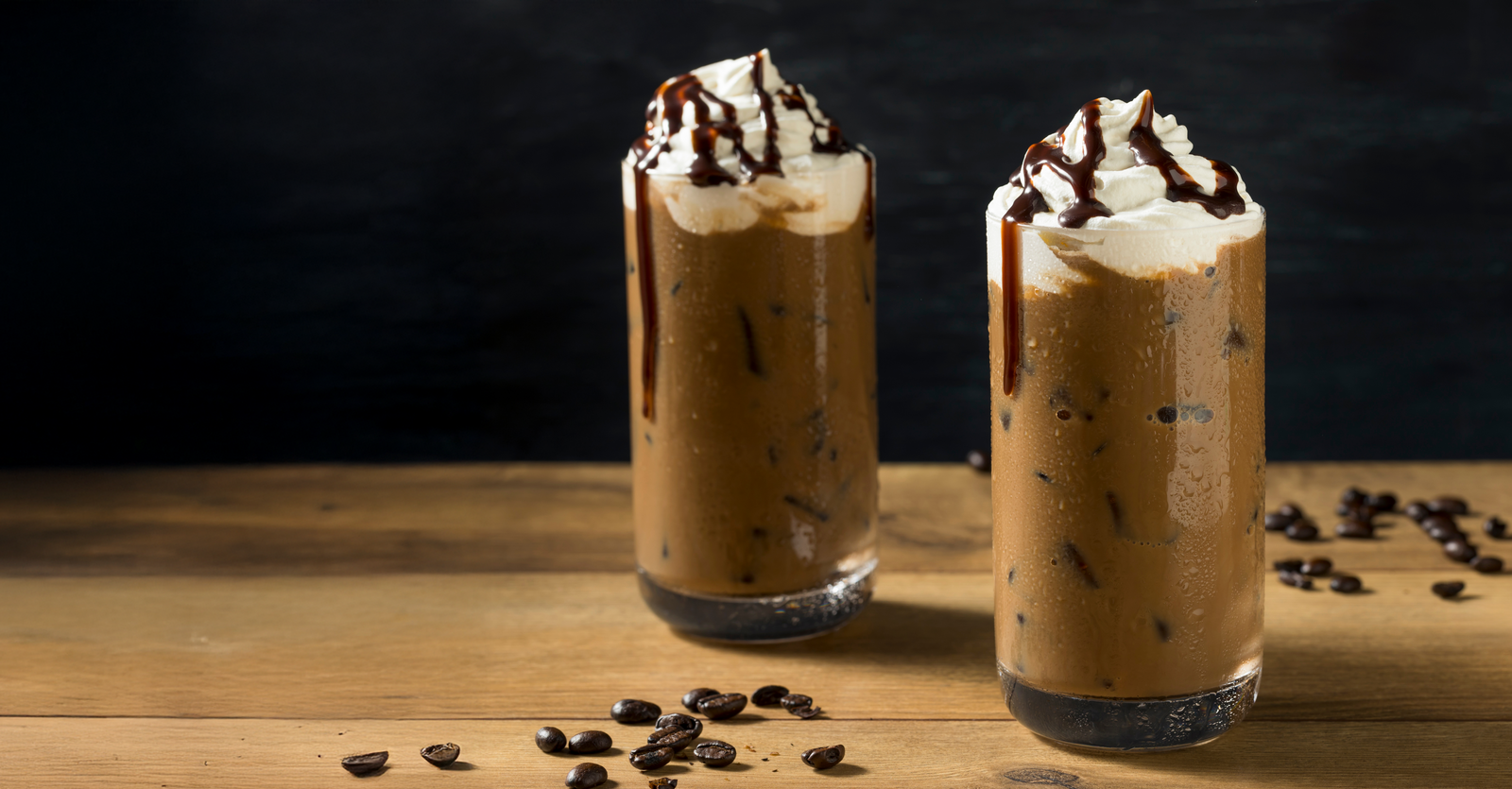 Iced mocha in a glass with coffee beans